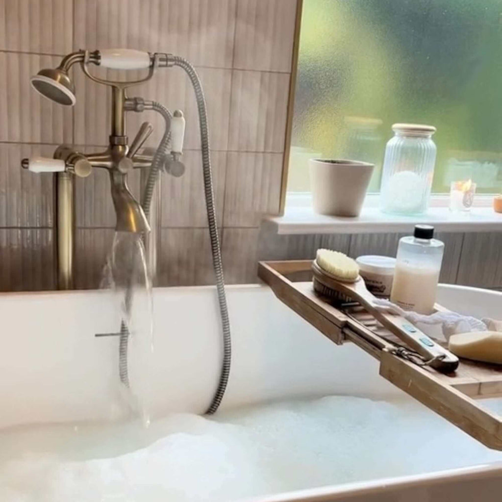 Downton floorstanding bath shower mixer tap with white ceramic levers - antique brass